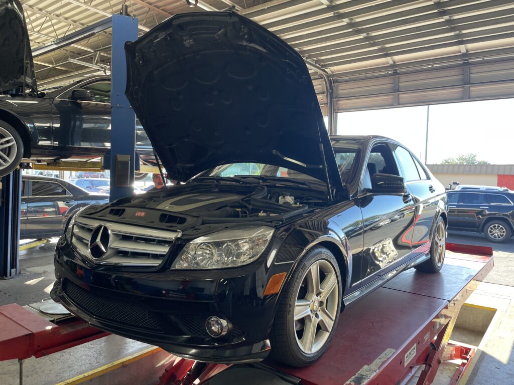 An incoming vehicle secured on a professional lift for a transparent digital inspection.